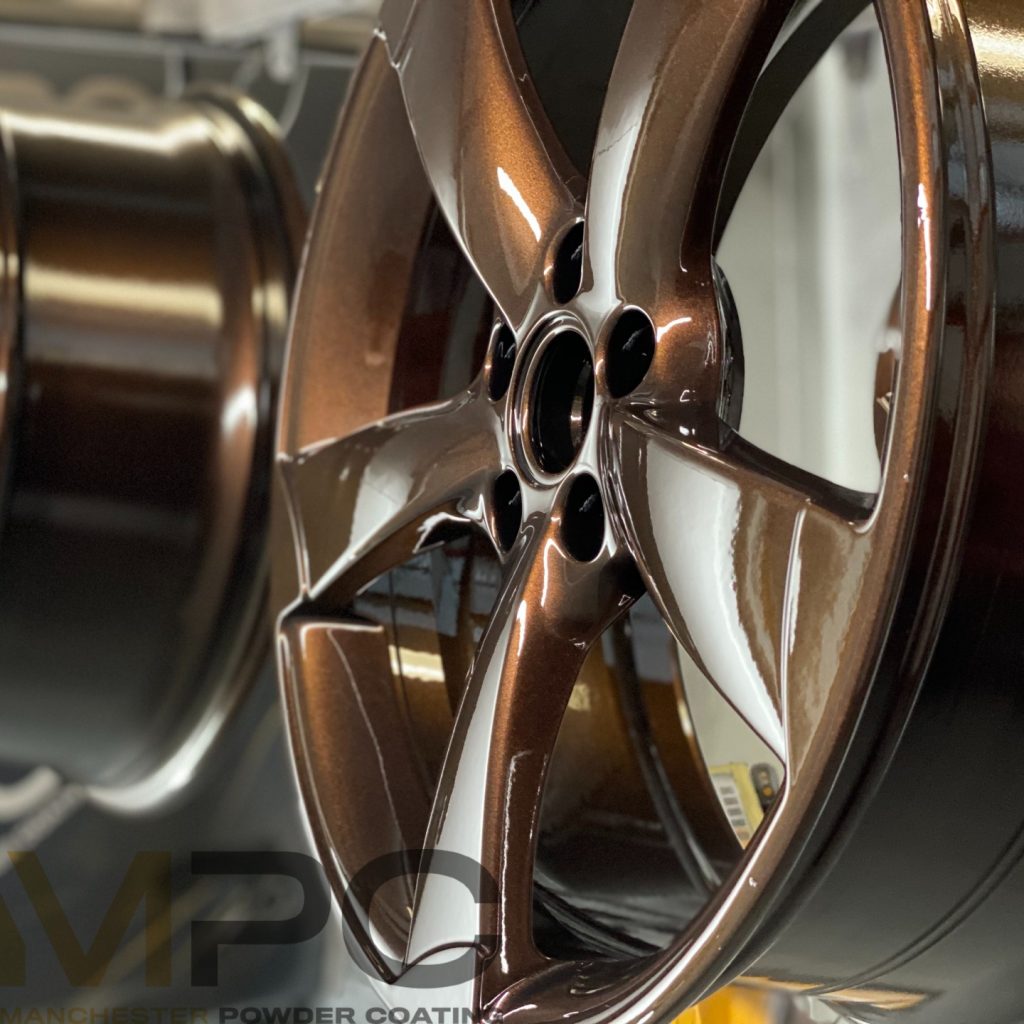 An image of a car alloy with a powder coating in liquid copper, which is a deep, sparkling red-brown.