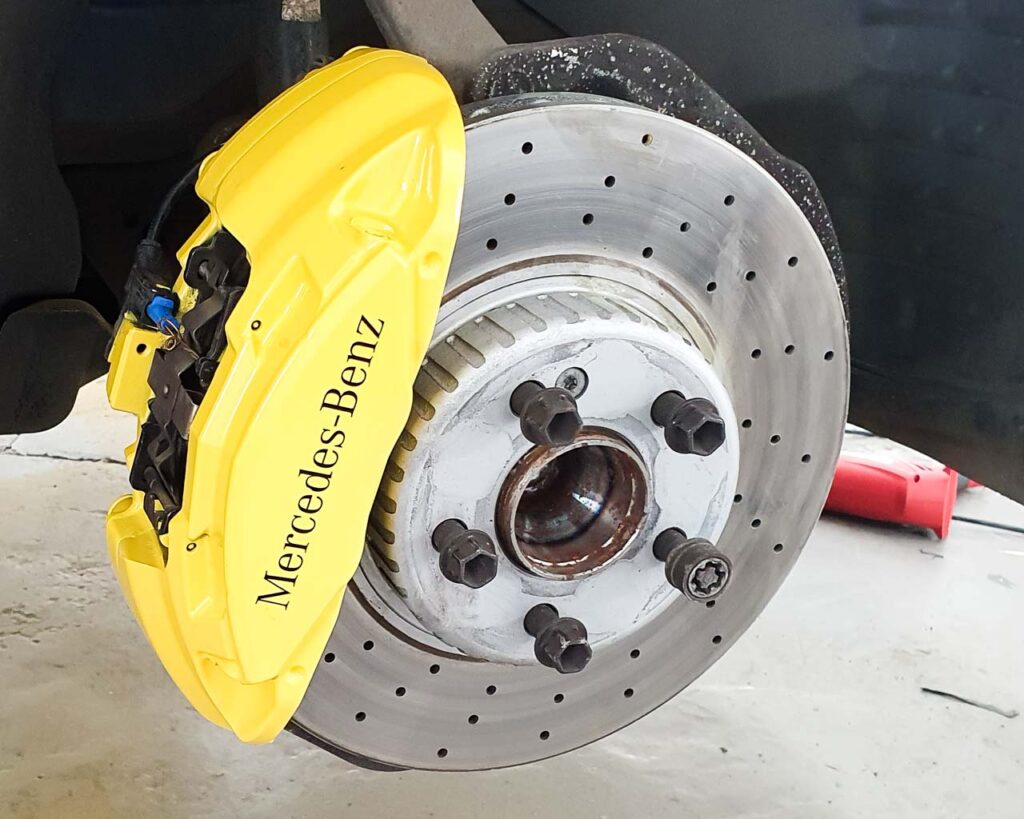 Mercedes callipers painted in yellow with a decal applied which reads mercedes-benz